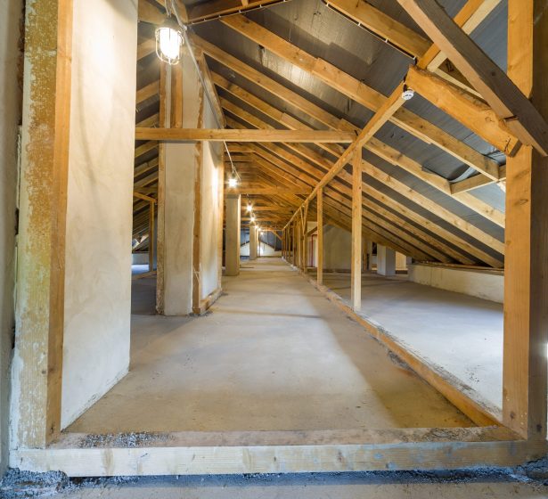 Attic of a building with wooden beams of a roof structure.