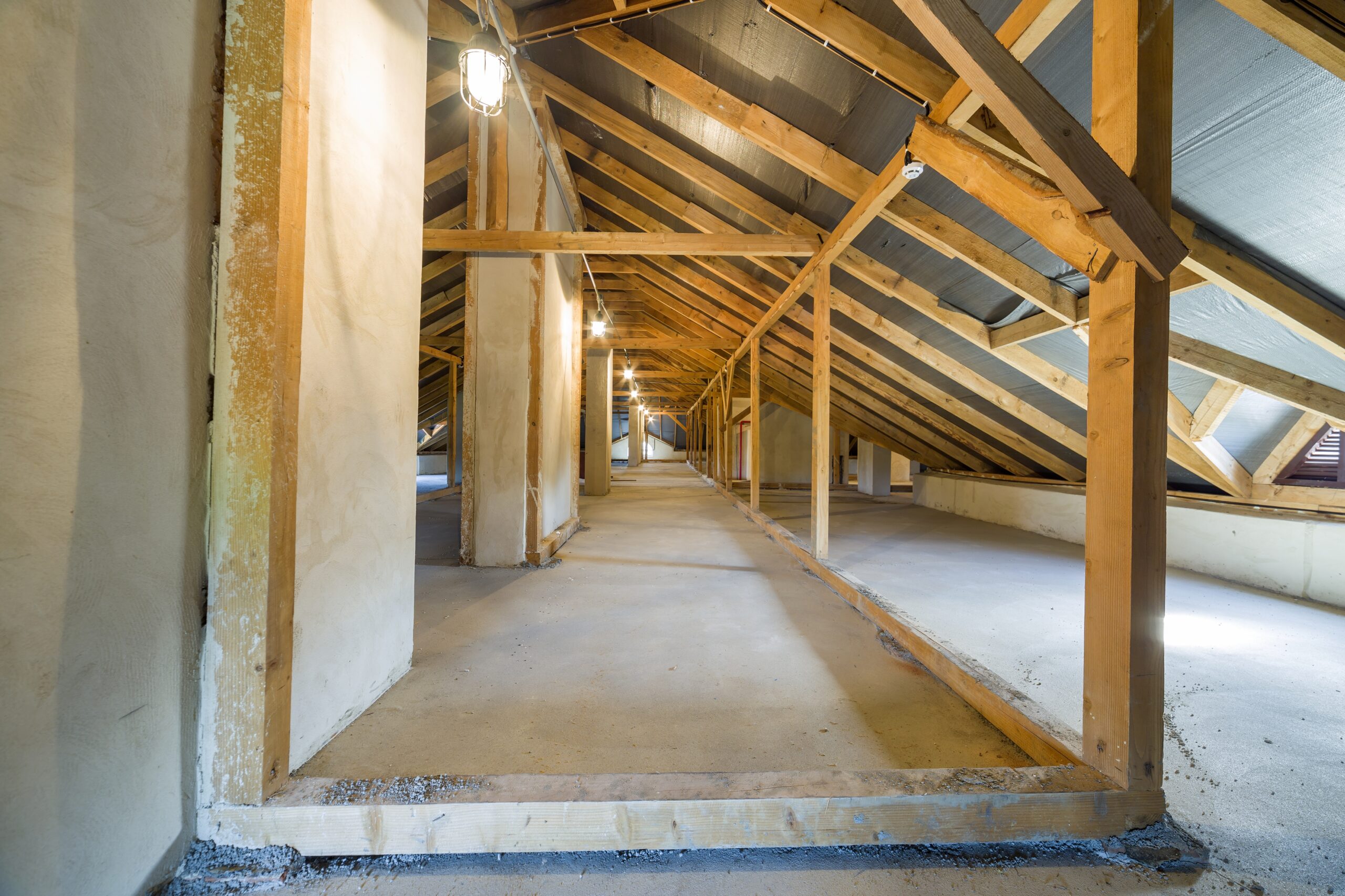 Attic of a building with wooden beams of a roof structure.